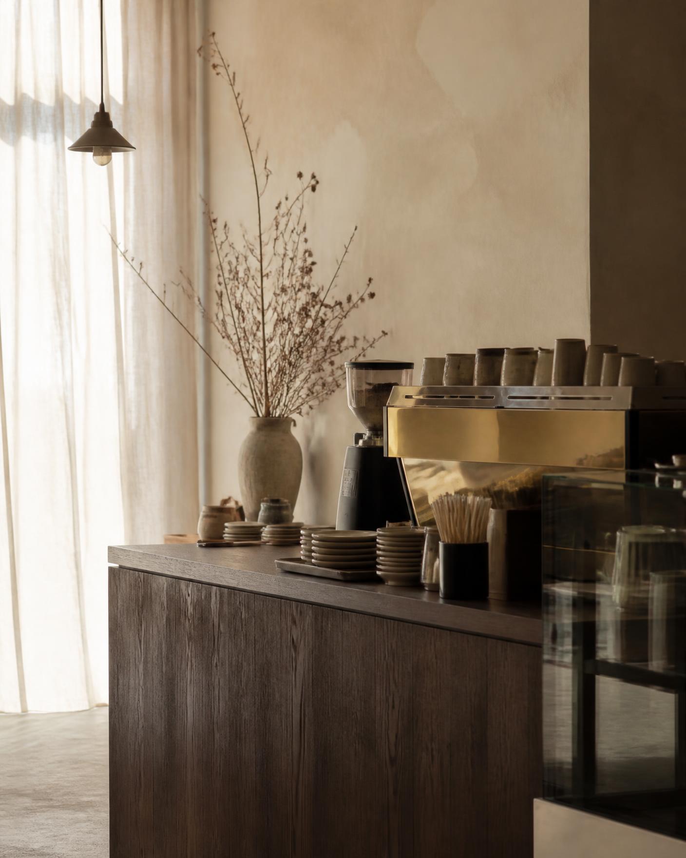 Warm café counter with brass espresso machine in morning light